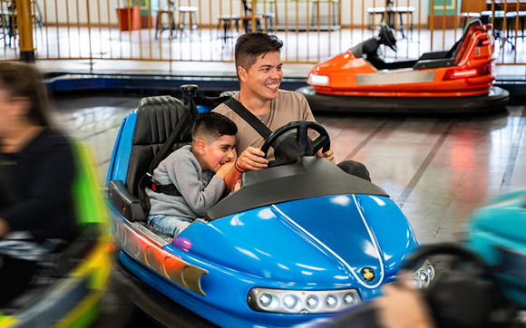 Adult and child driving a bumper car