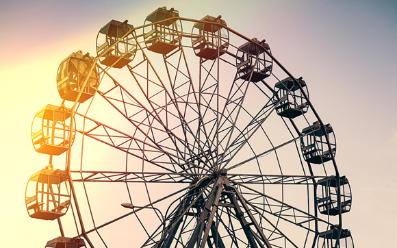 A long view a ferris wheel at sunset