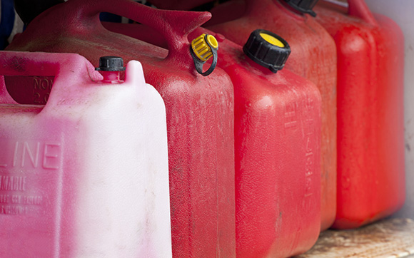 Collection of various used gas containers on a shelf